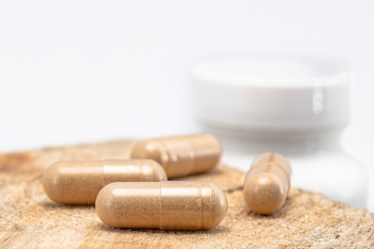 Close-up of ashwagandha capsules on wooden surface